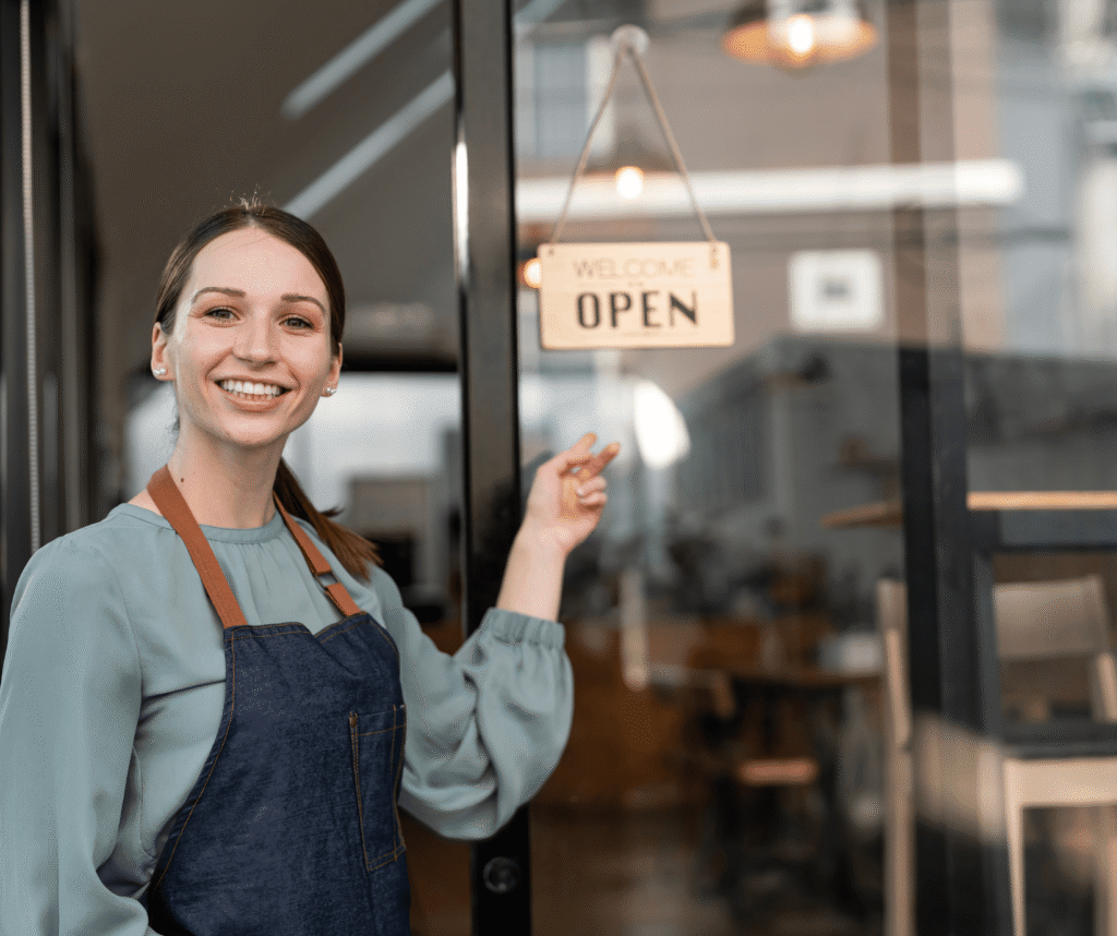 Woman outside store with open sign, symbolizing success with Nova Scotia small business marketing by Chrystal M Marketing